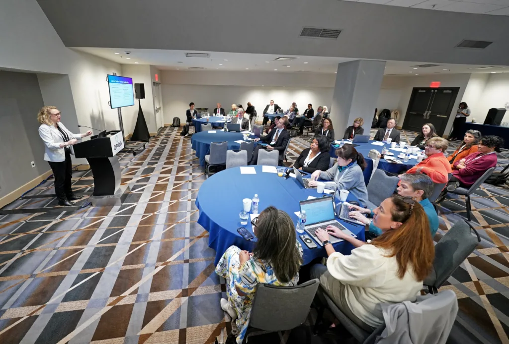 speaker and crowd at OPDA meeting